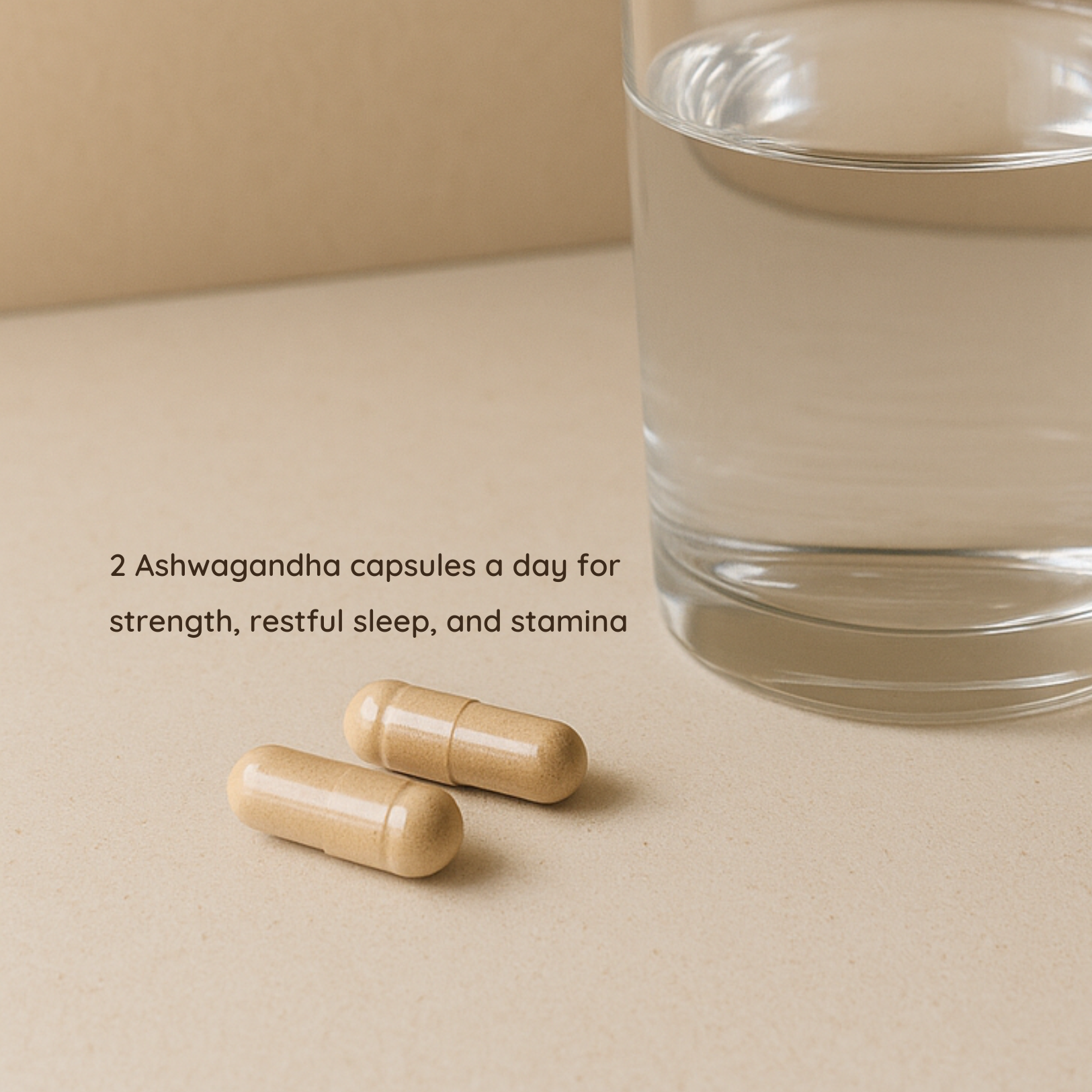 Two Ashwagandha capsules beside a glass of water with text recommending daily intake for strength, restful sleep, and stamina.