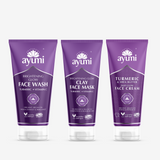 Three tubes of Ayumi brand skin care products, with the packaging indicating they are a brightening face wash, clay face mask, and face cream, each with purple and white colour scheme.