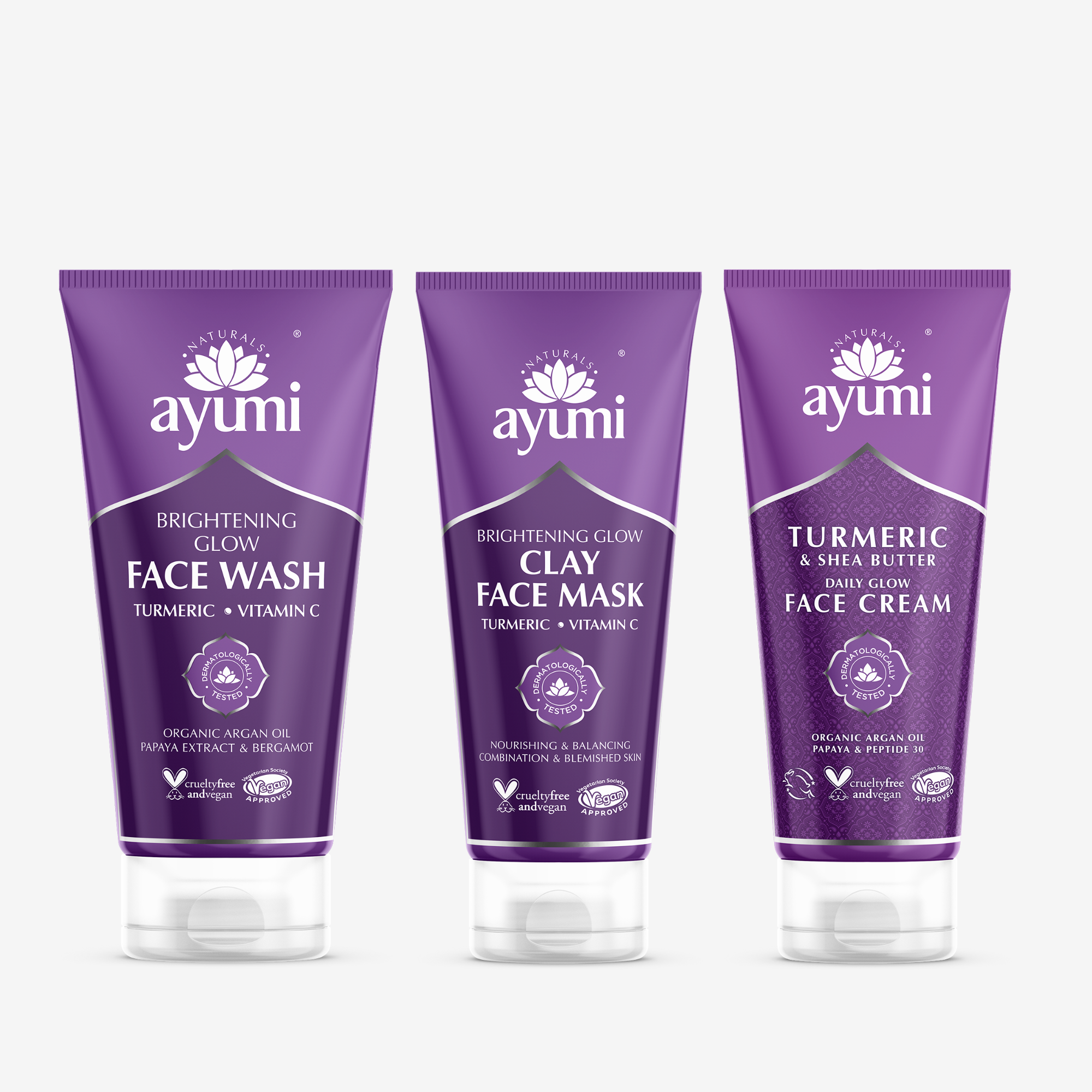 Three tubes of Ayumi brand skin care products, with the packaging indicating they are a brightening face wash, clay face mask, and face cream, each with purple and white colour scheme.