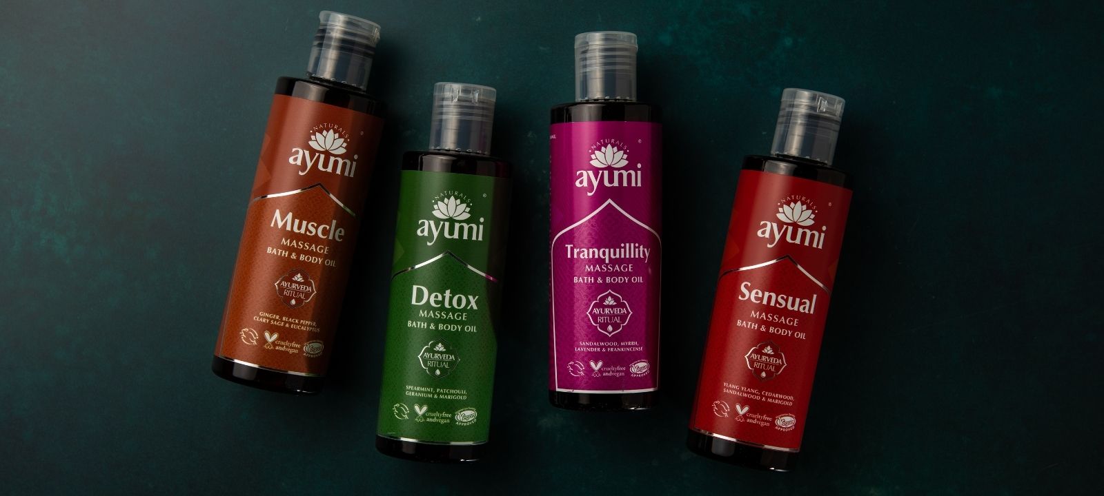 Showing all four Ayumi massage Oils on a dark back ground