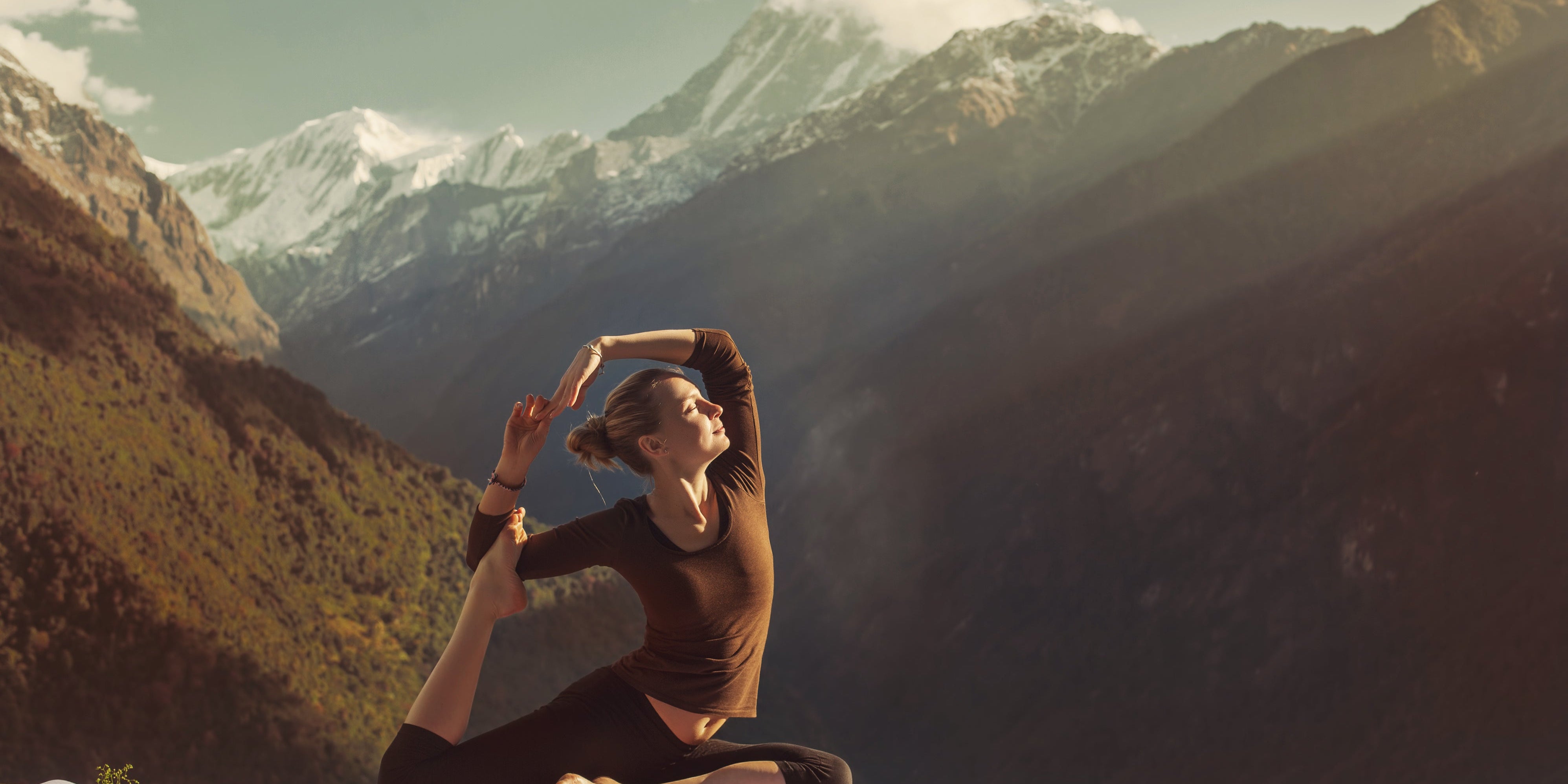 A woman doing Yoga in the Himalyan mountains