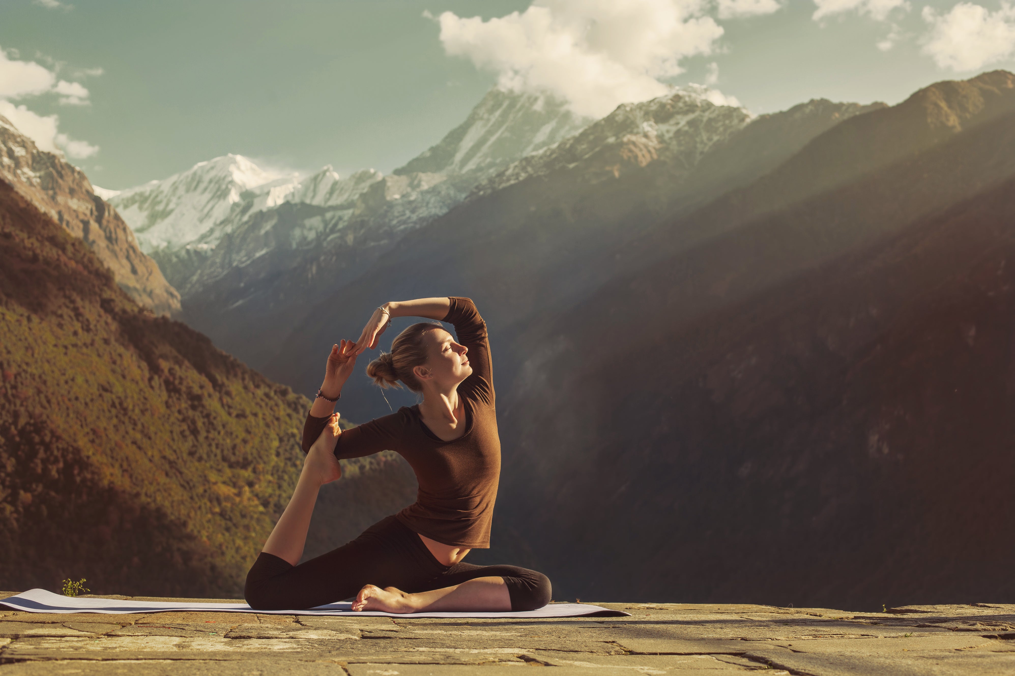 A woman doing Yoga in the Himalyan mountains