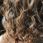 Close-up of wavy hair with a blurred background, washed hair