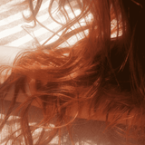 Close-up of red hair with a blurred background