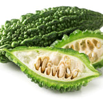 Karela Vegetable , sliced in half on a white background