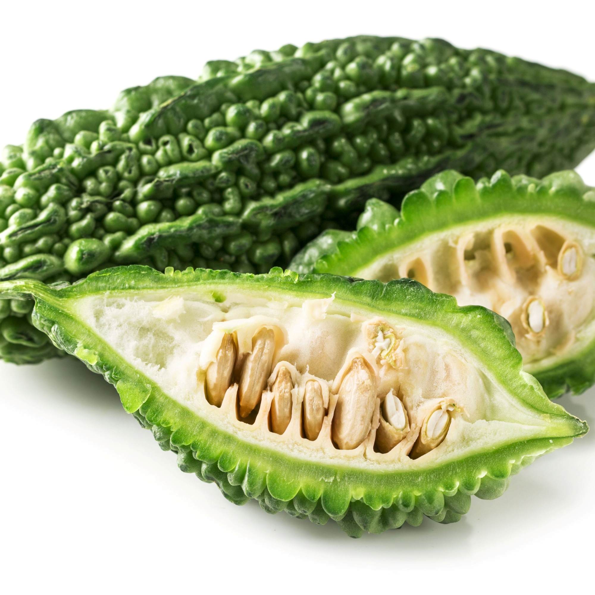 Karela Vegetable , sliced in half on a white background