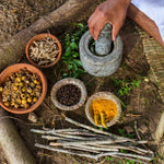 Raw herbs being ground by hand 
