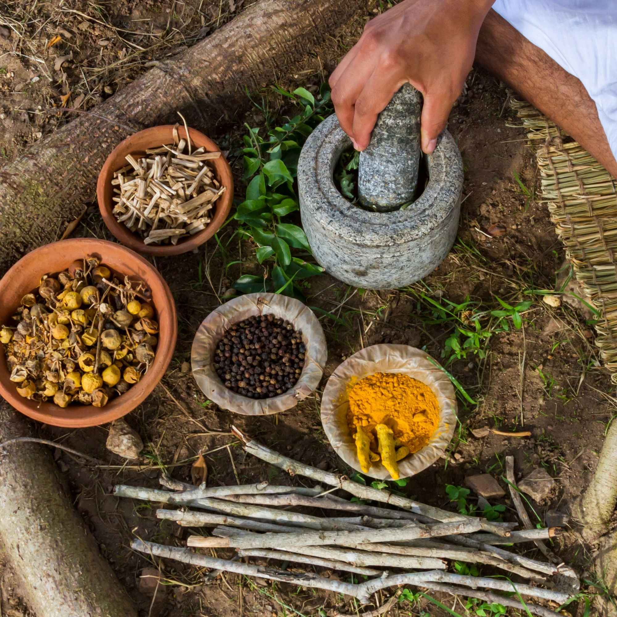 Raw herbs being ground by hand 