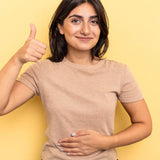 Woman giving a thumbs-up gesture against a yellow background