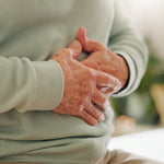 Older Person Holding Tummy Natural Gut Health and Digestive Support Ayumi Neem & Karela Capsules UK
