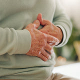 Older Person Holding Tummy Natural Gut Health and Digestive Support Ayumi Neem & Karela Capsules UK