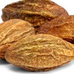 Close-up of dried haritaki fruit on a white background