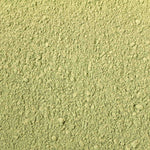 Close-up of green powder with a textured surface