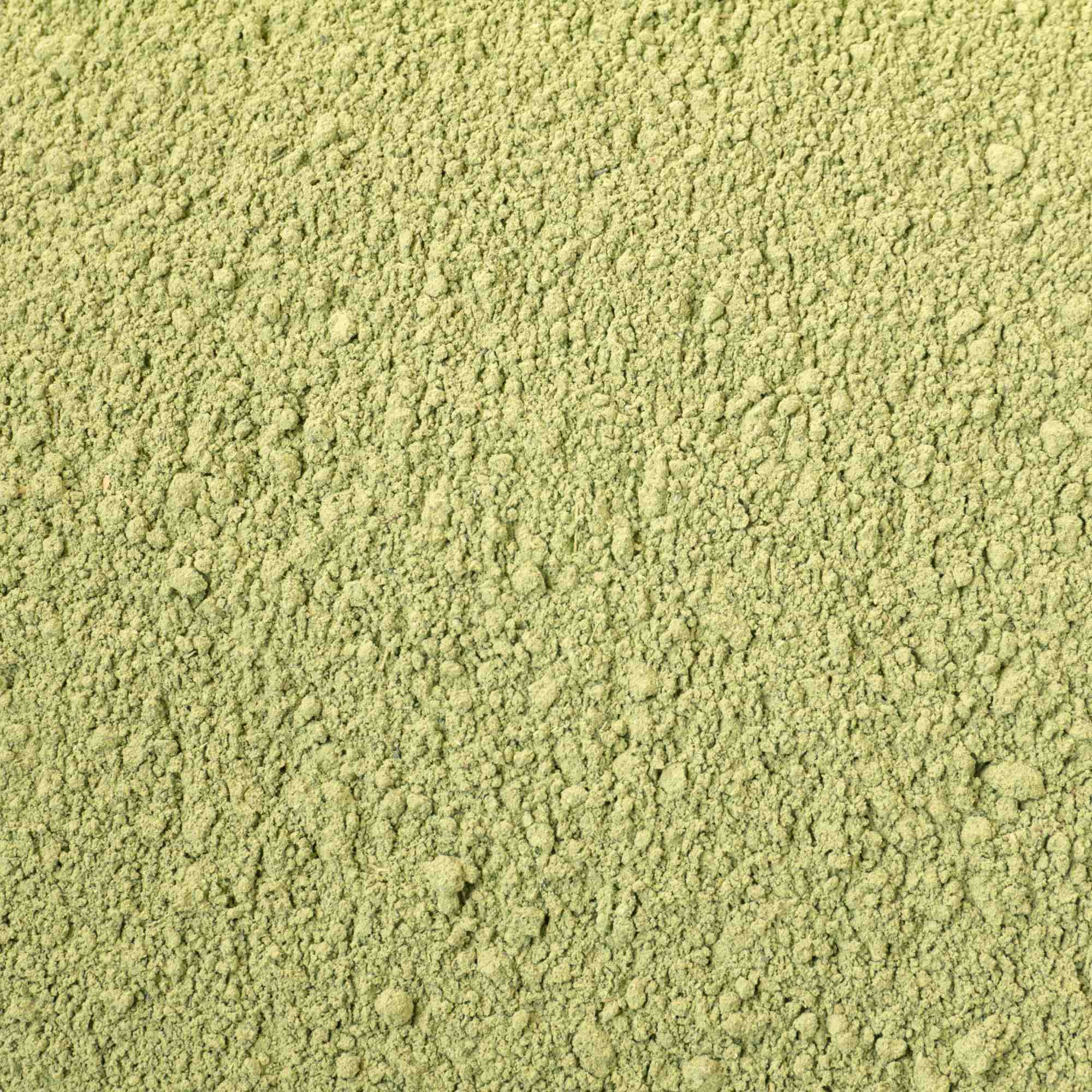 Close-up of green powder with a textured surface