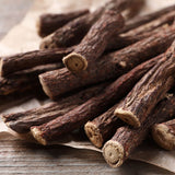 Close-up of dried licorice roots on a wooden surface