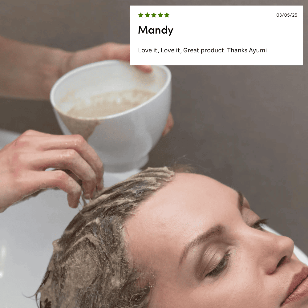 Person with hair being treated, holding a bowl of product, with a five-star review above.