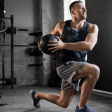 Man exercising with a medicine ball in a gym setting