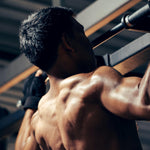 Muscular man exercising in a gym setting