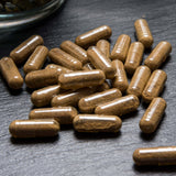 Guduchi capsules on a dark surface for Immunity